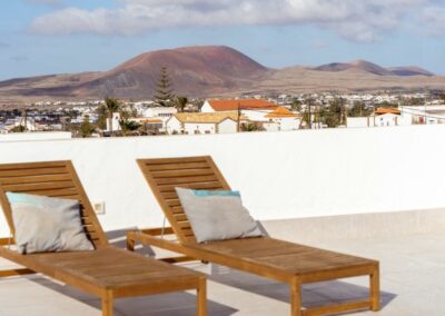 surfcamp lajares rooftop terrace with sunbeds in surfvilla kiana